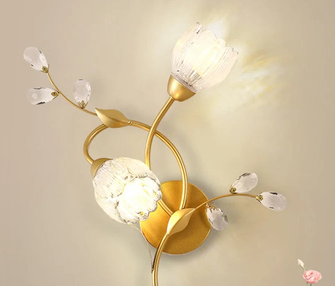 Decorative wall lamp with gold finish and crystal accents on a beige background