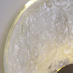 Close-up of a textured white surface with a gold rim