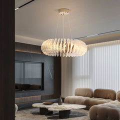 Modern living room with a chandelier, sofa, and coffee table.