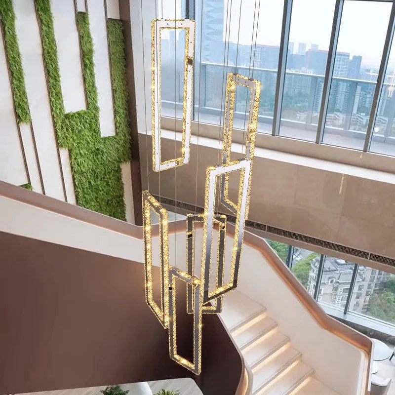 Modern chandelier hanging in a room with large windows and green wall decor