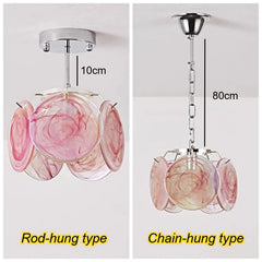 Rod-hung type floral glass pendant light in pink and white swirls, mounted close to the ceiling.