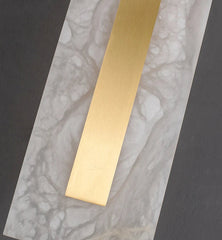 Gold strip on a marble surface with a dark background