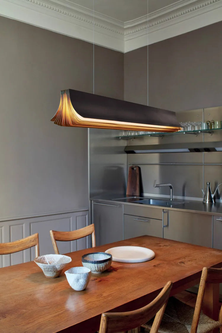 Modern kitchen with wooden dining table and pendant light