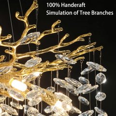 Gold and crystal chandelier with tree branch design on a black background