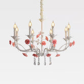 White floral crystal candelabra chandelier with pink roses and teardrop crystals, isolated on a white background.
