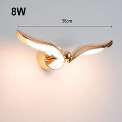 Gold wall light fixture with dimensions and wattage on a gradient background