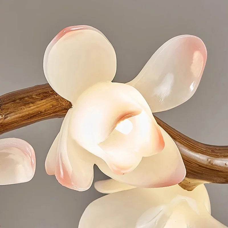 Decorative lamp with wooden base and glass shades on a gray background