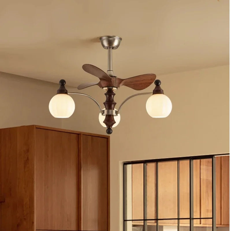 Ceiling fan with light fixture in a room with wooden cabinets and glass door.