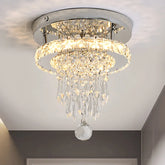 Close-up of a chrome and crystal tiered ring flush mount ceiling light with cascading crystals.