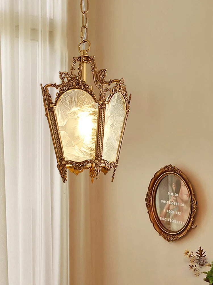 Decorative pendant light fixture on a wall with a framed picture below