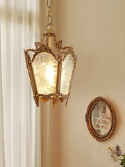 Decorative pendant light fixture on a wall with a framed picture below