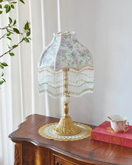 Decorative lamp with floral pattern on a wooden surface