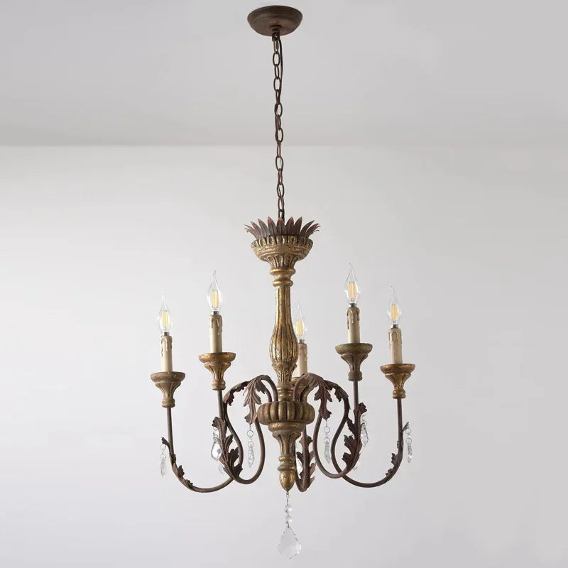 Vintage-style chandelier with five candle-like lights on a plain background