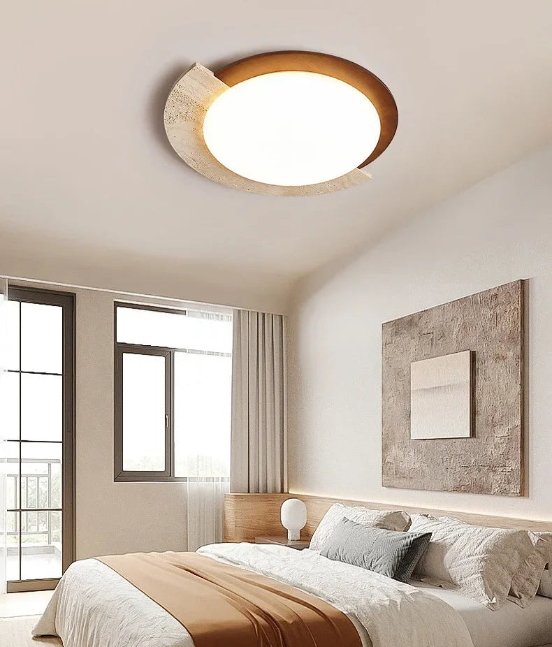 Modern bedroom with a ceiling light fixture, bed, and window.