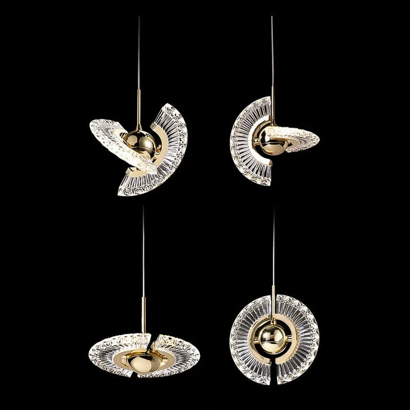 Set of four modern pendant lights with gold and clear design on a black background