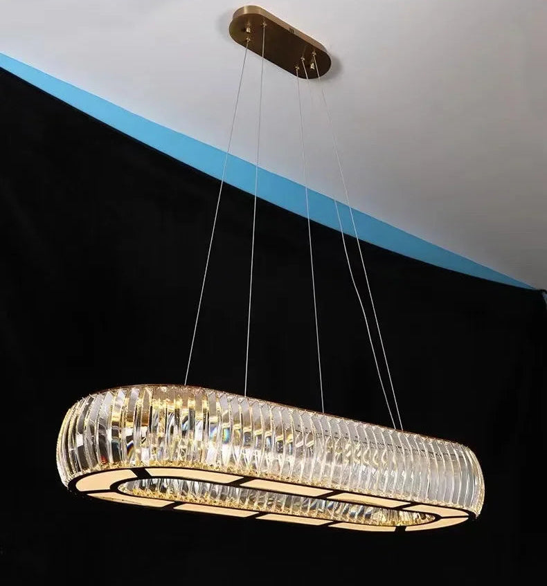 Modern chandelier hanging from the ceiling with a black and blue background