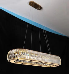 Modern chandelier hanging from the ceiling with a black and blue background