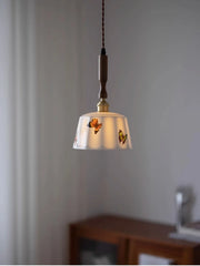 Pendant light with floral design on a neutral background
