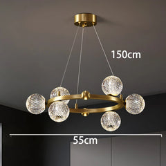 Gold chandelier with crystal balls, shown against a dark background with measurements indicated.