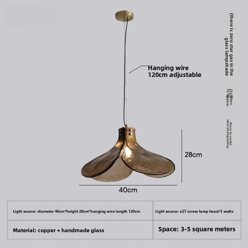 Gold pendant light with adjustable hanging wire on a gray background