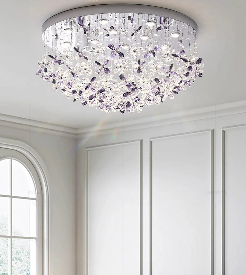 Ceiling light fixture with purple accents in a room with white walls and a window.
