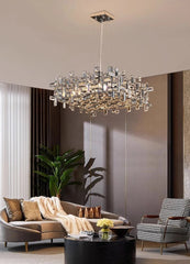 Chandelier hanging in a living room with a sofa and chair.