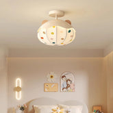 White ceiling light shaped like a hot air balloon with colorful polka dots and wooden bear ears, mounted on a white ceiling.