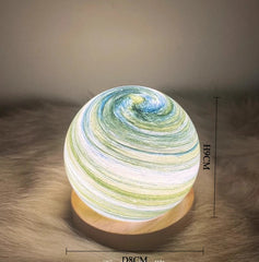 Decorative lamp with swirling pattern on a textured surface, showing dimensions.