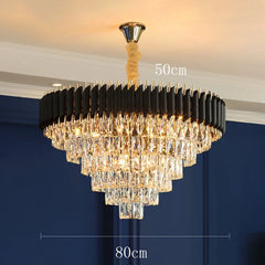 Chandelier with black and gold design against a blue wall