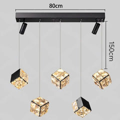 Modern pendant light fixture with crystal cube shades and dimensions on a gray background
