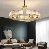 Gold tiered chandelier with crystal accents hanging in a modern living room.