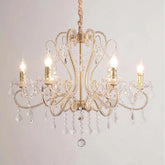 Gold candelabra chandelier with clear crystal accents and warm lighting.