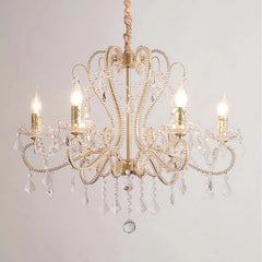 Gold candelabra chandelier with clear crystal accents and warm lighting.