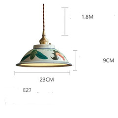 Pendant light with decorative design and measurements on a white background