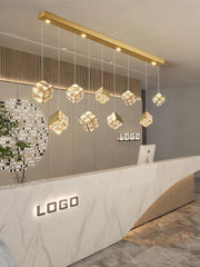 Modern interior design with a reception desk and decorative ceiling lights.