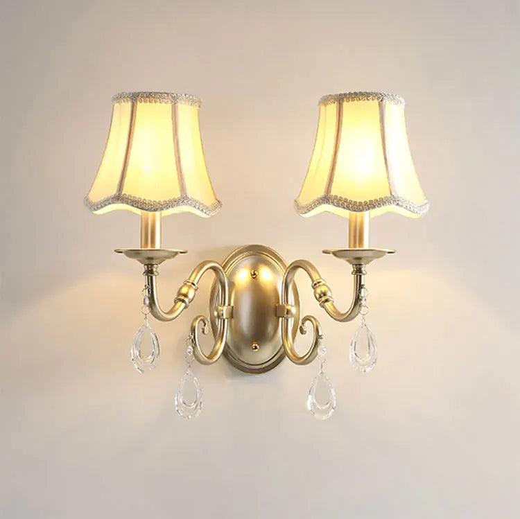 Pair of wall lights with decorative lampshades and crystal accents on a plain background