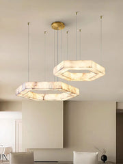 Two modern pendant lights hanging from the ceiling in a room with neutral walls.
