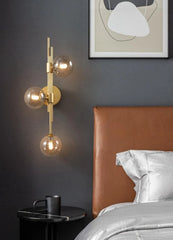 Modern Gold Brass Sconce with Three Frosted Globe Shades