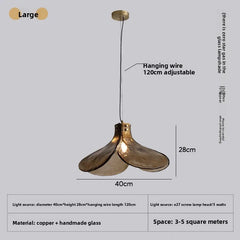 Gold pendant light with adjustable hanging wire on a gray background