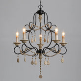 Black iron chandelier with wood beads and cascading crystal accents, featuring five candle-style lights.
