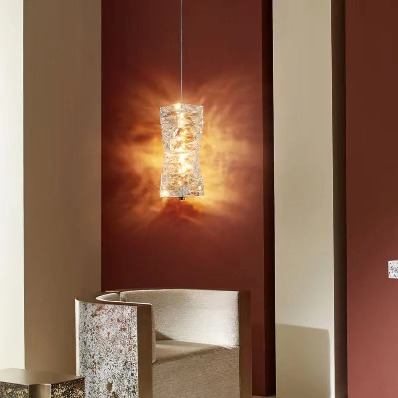 Modern pendant light fixture hanging in a room with a warm glow.