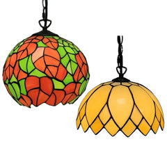 Two Tiffany style stained glass pendant lights, one orange and green, one yellow, displayed side-by-side