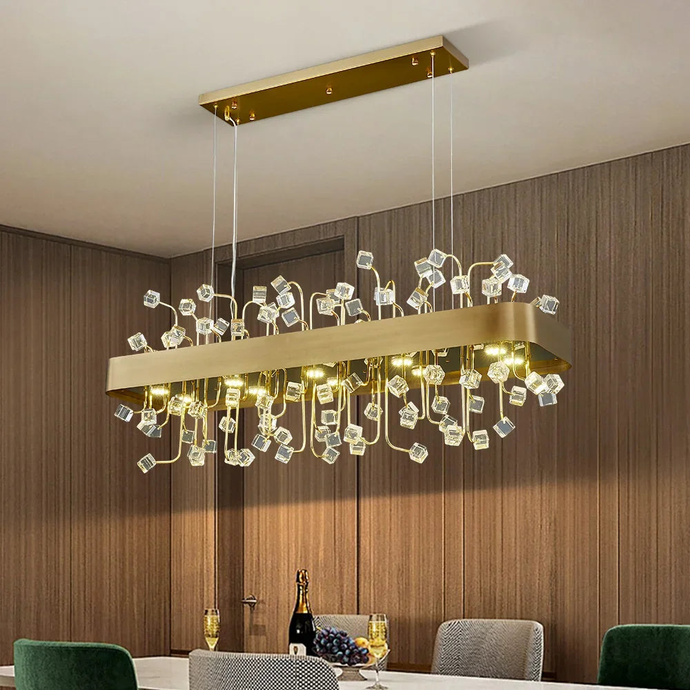 A close-up view of a rectangular gold chandelier with clear crystal accents.