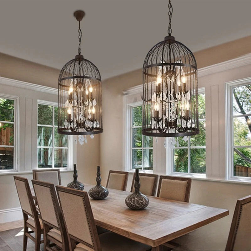 Dining room with chandelier-style pendant lights hanging above a wooden table.