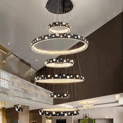 Modern chandelier with multiple rings hanging from a ceiling
