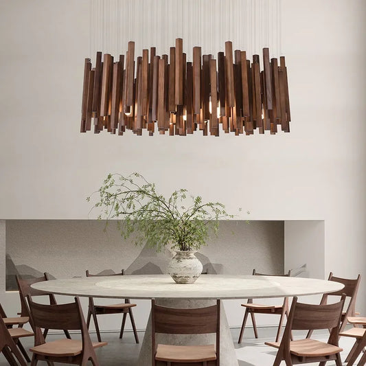 Rectangular wooden stick chandelier with warm lighting above a round dining table