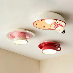 Three ceramic coffee cup ceiling lights mounted on a white ceiling, each emitting a warm glow.