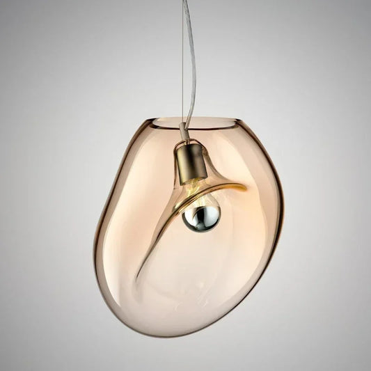Amber glass organic shape pendant light with a visible bulb and cord.