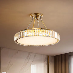 Ceiling light fixture with crystal design in a room with marble walls and curtains.