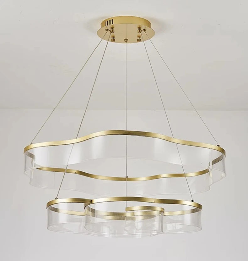 Gold and clear glass pendant light fixture on a white background